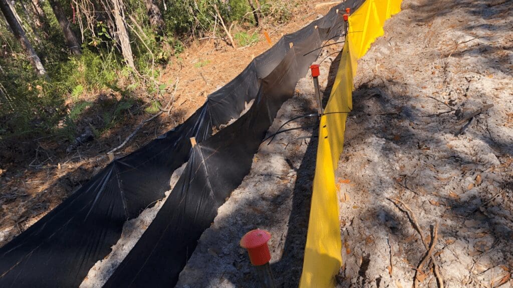 Construction site trench with protective barriers and safety measures.