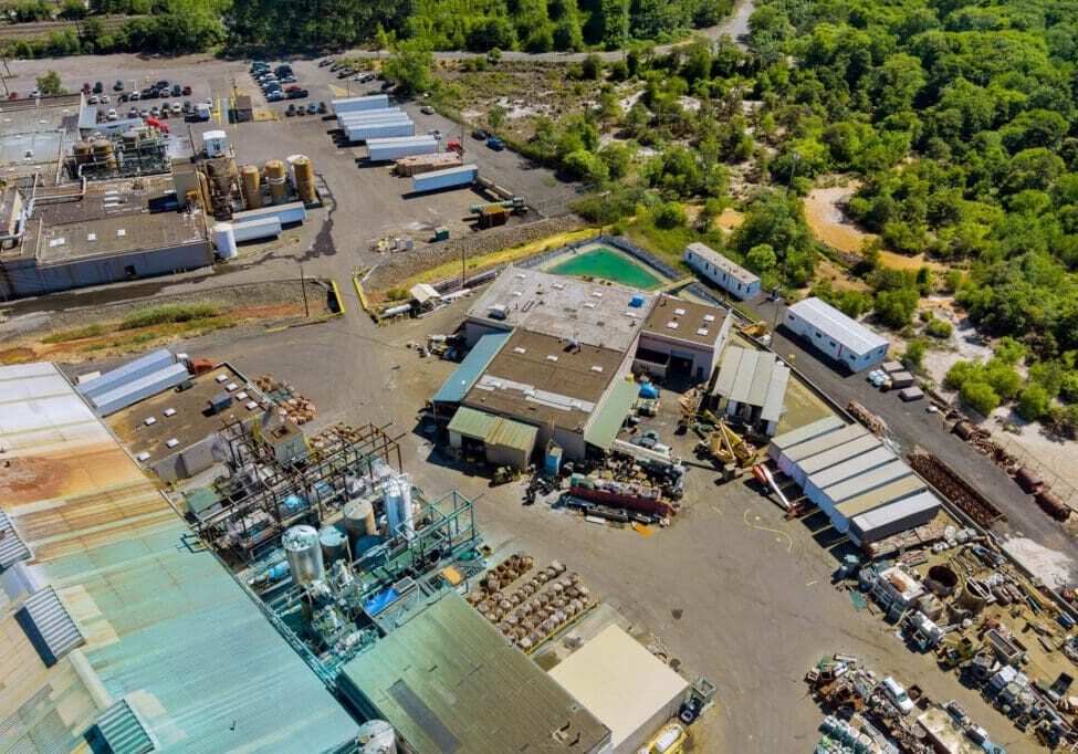 Aerial view of an industrial storage yard with machinery and materials.