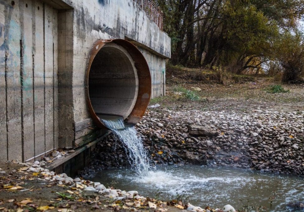 discharge-wastewater-into-river-through-large-rusty-pipe_inPixio-scaled