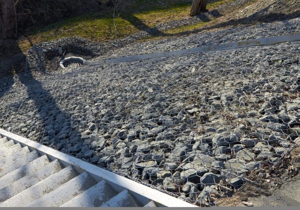 A gravel-covered roof with a small animal near the top edge.