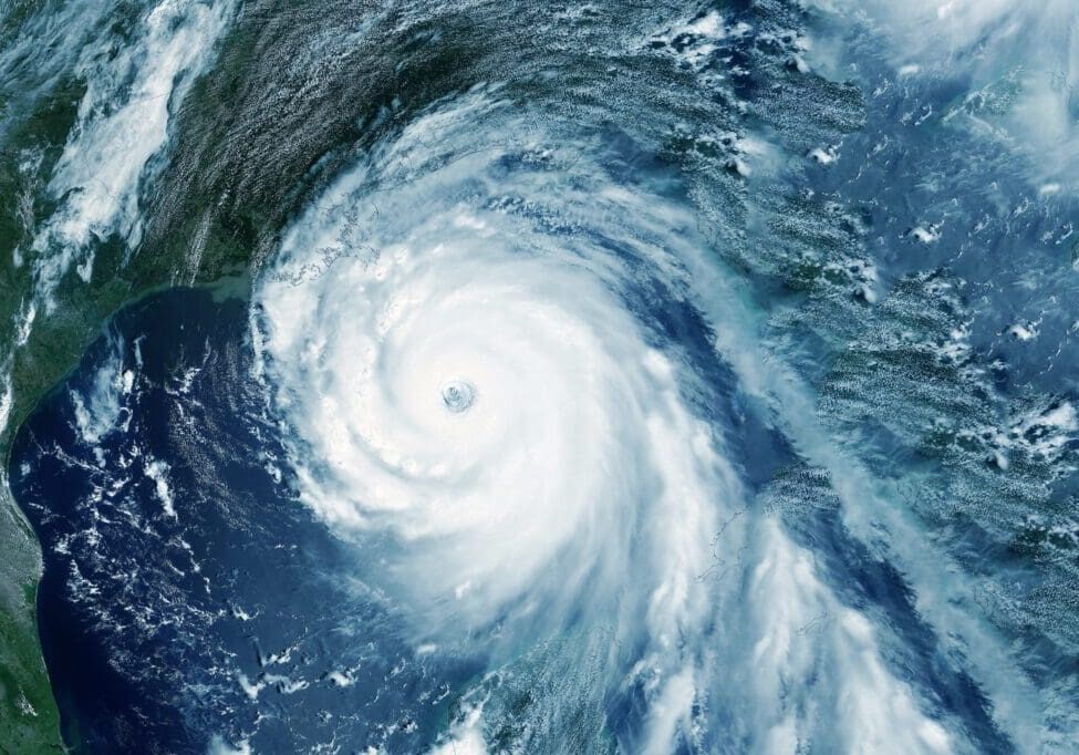 A large hurricane swirling over the ocean with a clear eye.