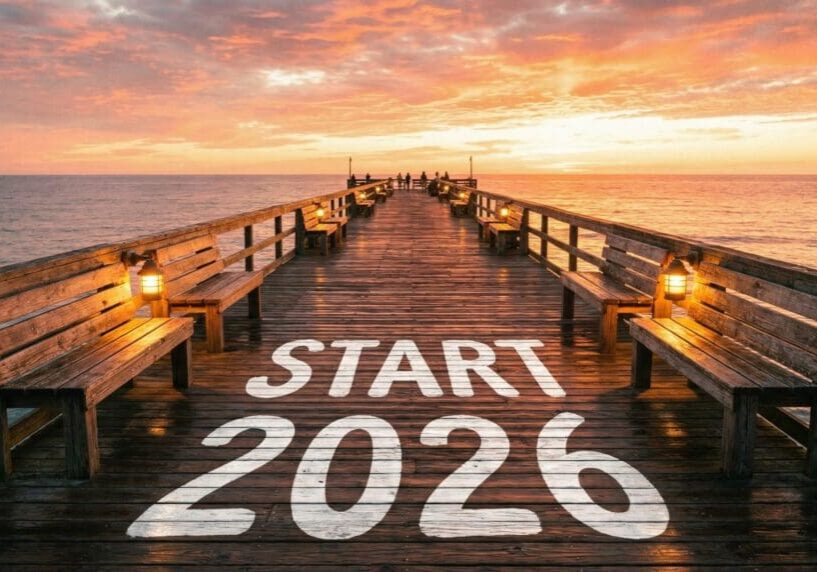 A wooden pier at sunset with 'START 2026' painted on the floor.