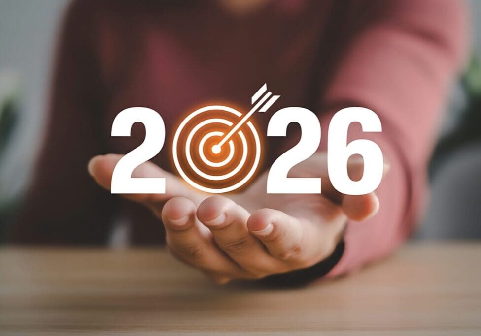 Hand presenting a 2026 target symbol, symbolizing future goals.